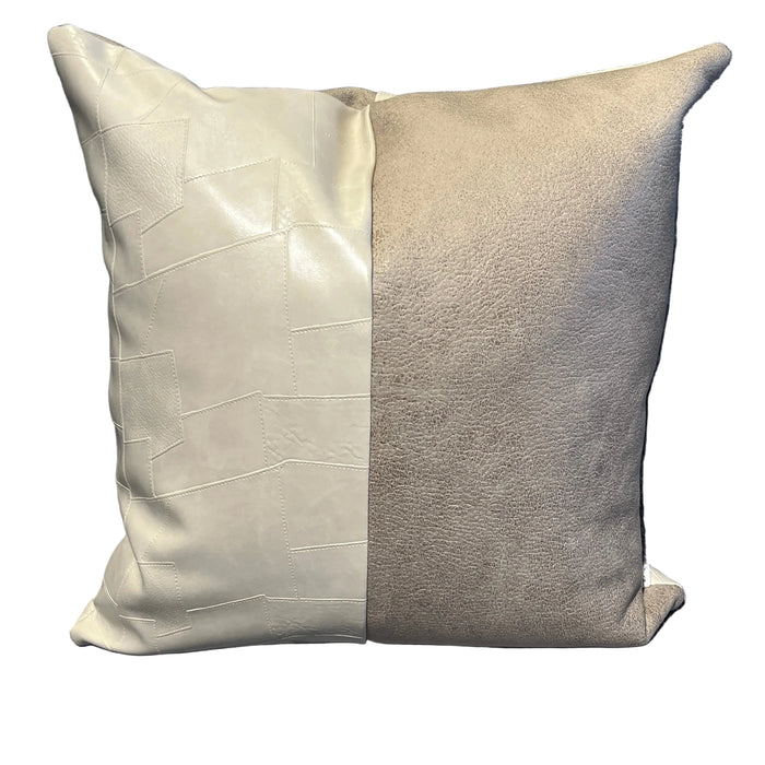Two pillows, one gray and one beige, on a textured surface.