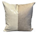 Two pillows, one gray and one beige, on a textured surface.