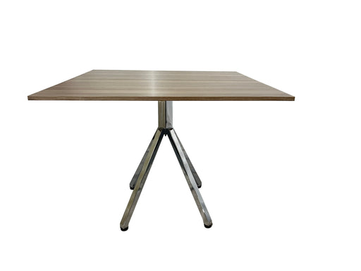 Wooden table with metal legs on a white background