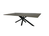 Modern dining table with wooden top and black metal legs on a white fabric-covered floor.