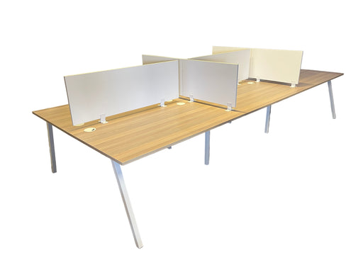 Wooden office desk with white partitions in a room with a white tarp.
