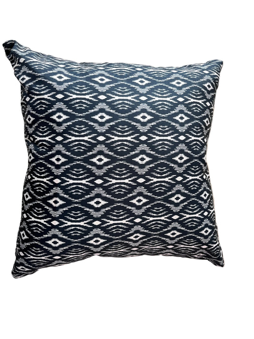 Decorative pillow with black and white pattern on a beige background
