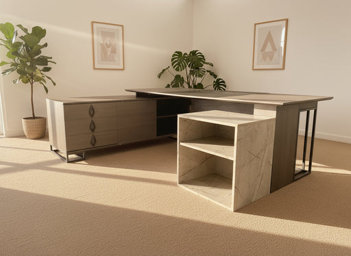 Modern office desk with storage drawers and shelves on a gray carpeted floor.