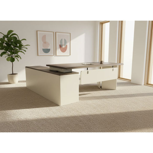Beige office desk with a gray top on a gray floor against a white backdrop