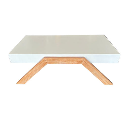 White table with wooden legs on a carpeted floor