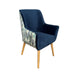 Navy blue cushion on a chair with a concrete floor and white fabric in the background
