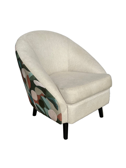 Small ottoman with a floral pattern on a concrete floor