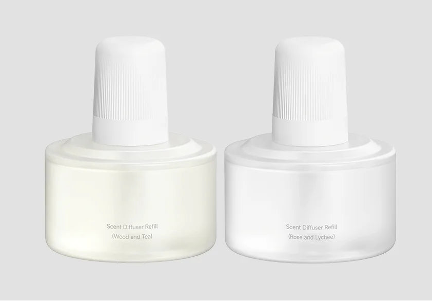 Two white nail polish bottles on a light gray background